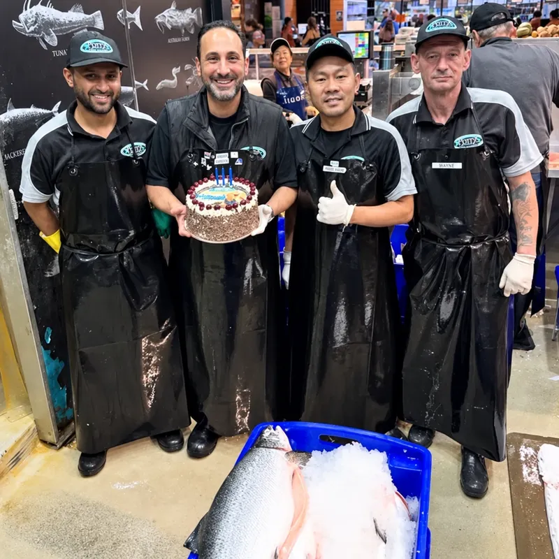 Barry and the team in their aprons in front of the counter
